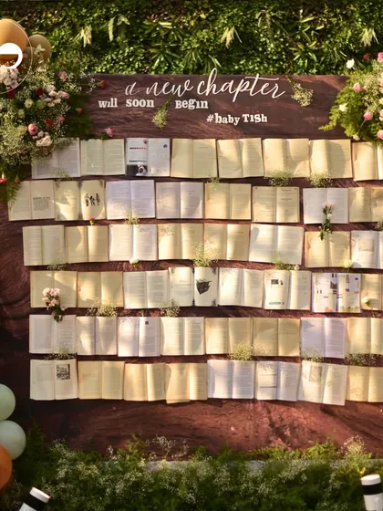 For a "New Chapter" themed shower, I created this unique backdrop from dozens of open books. Each book was accented with delicate flowers, symbolizing the new stories and adventures awaiting the parents to be. It's a testament to how we can weave your personal story into every detail.
