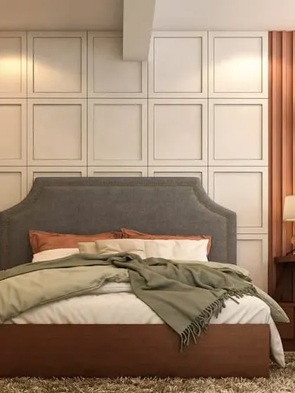 This guest bedroom combines comfort with functionality. The wall behind the bed features a mix of paneled and fluted textures, with an integrated desk and chair creating a compact and stylish workspace.
