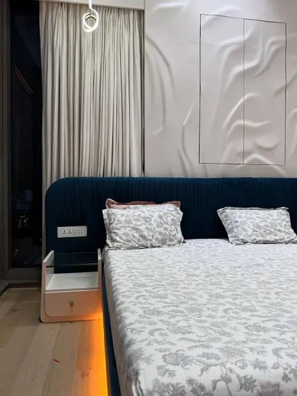 Another angle of the master bedroom, showing the interplay of the ambient under-bed lighting, the dramatic 3D wall, and the soft curtains.