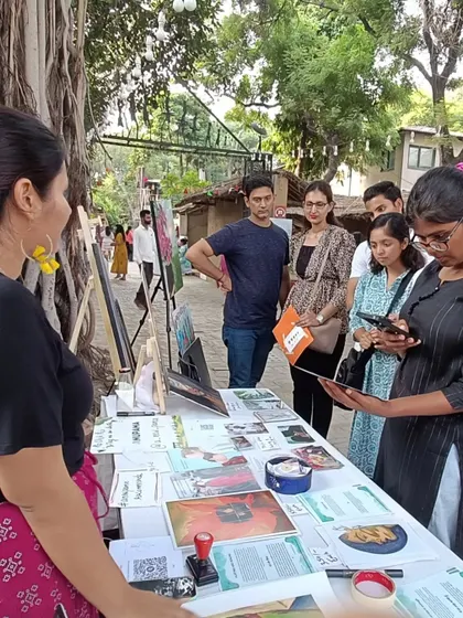 A group of people gathered at my stall, looking through postcards and prints. I love creating these small, accessible pieces of art so that anyone can take a bit of the magic home with them.