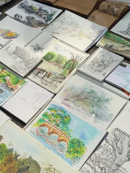 This image shows the collective work from a sketching event with Urban Sketchers Mumbai. It's wonderful to see so many different interpretations of the same location, with sketchbooks spread out on the ground, each telling its own story.