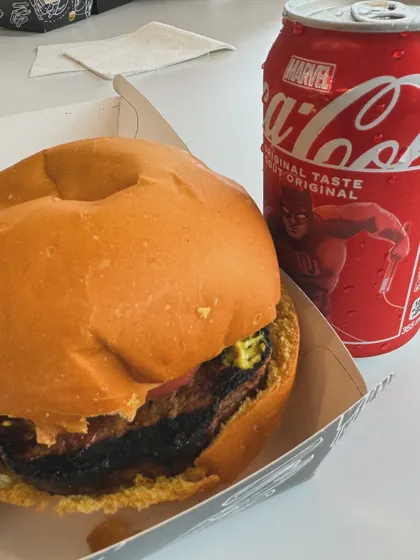 A delicious-looking burger and a Marvel-themed Coca-Cola, a snapshot of my lunch.