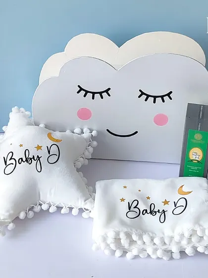 The complete 'Touch of Heaven' hamper set. It includes a cloud-shaped storage box, a star-shaped pillow, and a soft blanket, all personalized for "Baby D," creating a dreamy and cohesive gift for new parents.