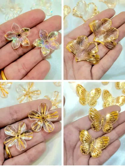 These decorative acrylic add-ons, including iridescent flowers and golden butterflies, are perfect for embellishing resin art. They catch the light beautifully when embedded in resin.