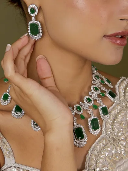 A beautiful emerald and diamond-look set, crafted for those timeless moments. This image shows the delicate earrings that complete the ensemble.