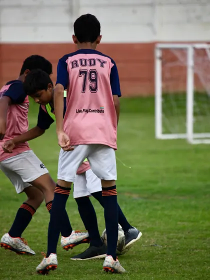 Players battling for possession of the ball. These moments of intense competition are where our players learn to be strong and think quickly under pressure.