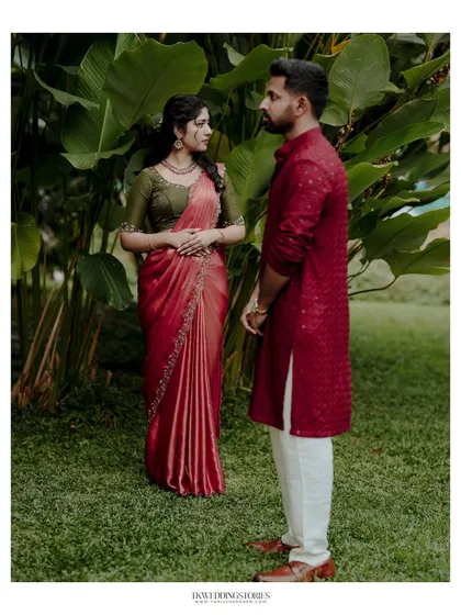 A stylish portrait of a couple in a garden setting, showcasing their coordinated outfits and confident poses. This is great for post-wedding or pre-wedding sessions.
