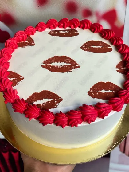 A unique and playful "Kisses on Cake" design, featuring lipstick prints and a bold red border.
