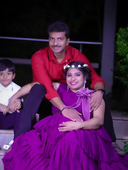 A complete family portrait, with the parents and their son posing together during the maternity shoot.