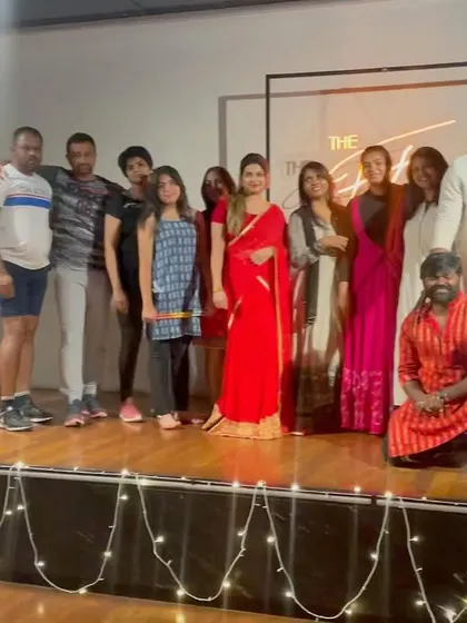 The team and participants posing on stage during our Dandiya event.