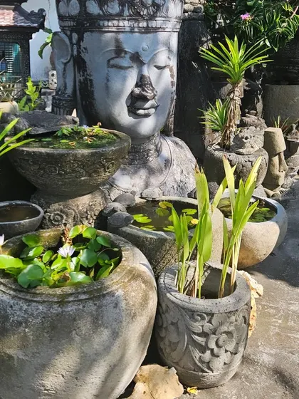 A collection of stone planters and a large Buddha statue, weathered to perfection. We travel to find unique pieces that will make your garden truly one of a kind.