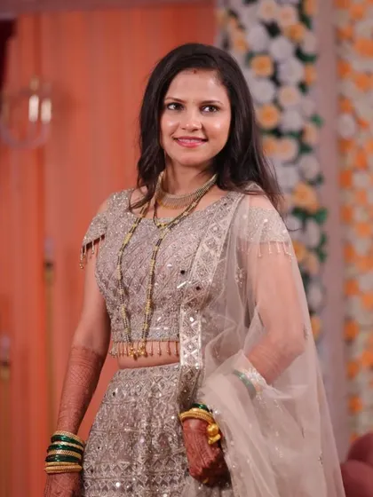 Asmita's full reception look, featuring a stunning silver lehenga. The soft, open hairstyle and radiant makeup allowed her to look effortlessly chic and comfortable throughout the celebration.
