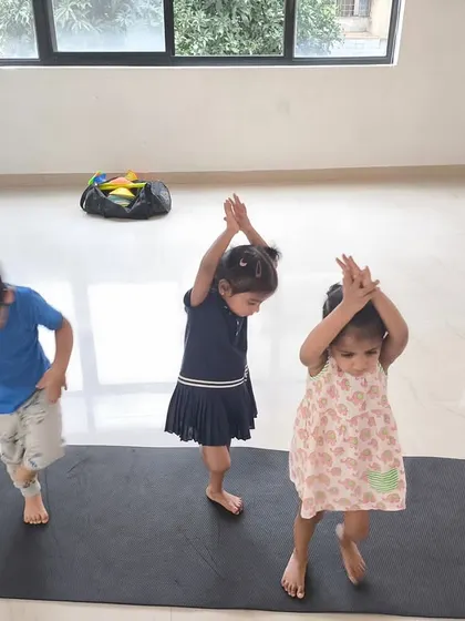 Little athletes practicing their balance and coordination, reaching for the sky in our indoor studio.