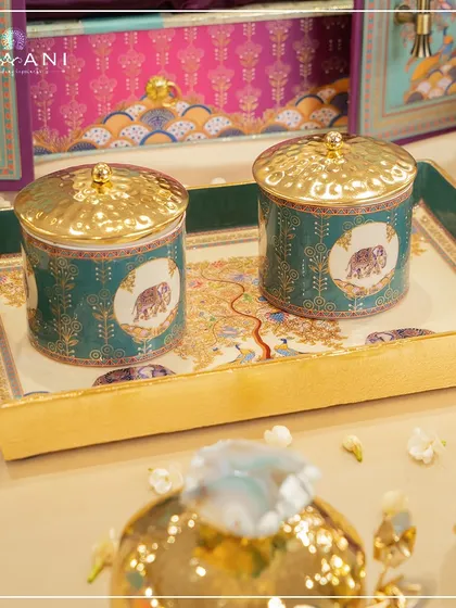 The Tree of Life collection is rich with symbolism, as seen in these beautiful jars and tray. The elephant motifs represent strength and prosperity, making these pieces a meaningful part of any wedding celebration.
