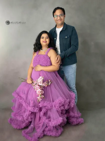 A vision in purple. This ruffled gown is a statement piece, and paired with a simple background, it creates a portrait that is both bold and beautiful.
