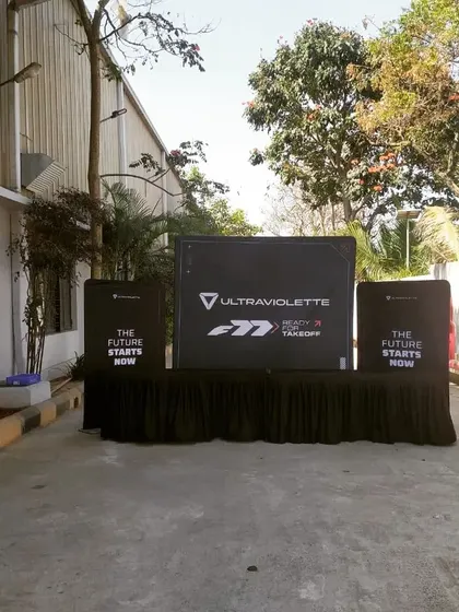 An outdoor branding and registration setup for the Ultraviolette launch. I create a cohesive brand experience from the moment guests arrive, with custom-printed counters and clear signage.