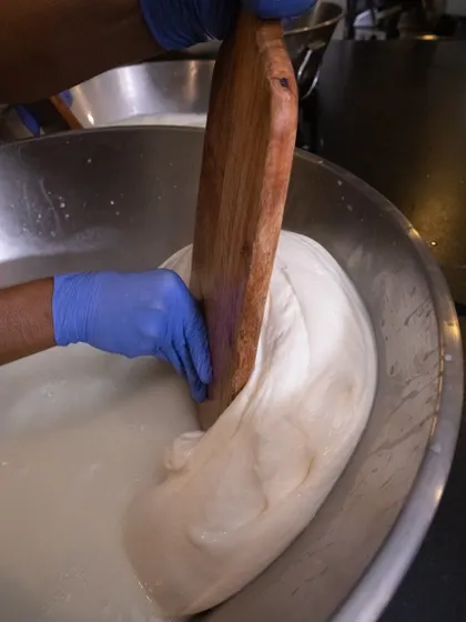 The stretching continues. This process is physically demanding but absolutely necessary for creating authentic, high-quality mozzarella that is soft and milky.