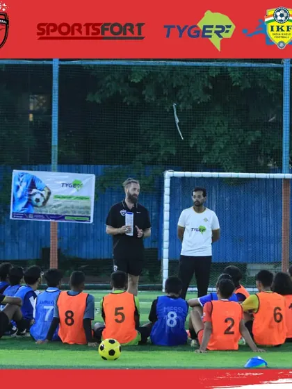 A coach from the Pro Soccer Global workshop gives a briefing to a group of young, attentive players. These sessions provide invaluable insights from international experts.