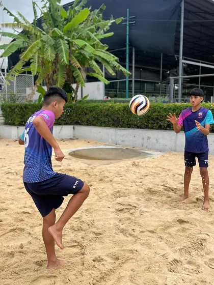 Players practicing ball control on the sand, a challenging drill that significantly improves touch and technique.