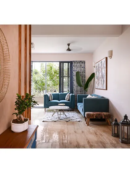 A wider view from the foyer, showing how the living room is arranged to maximize light from the large balcony doors.