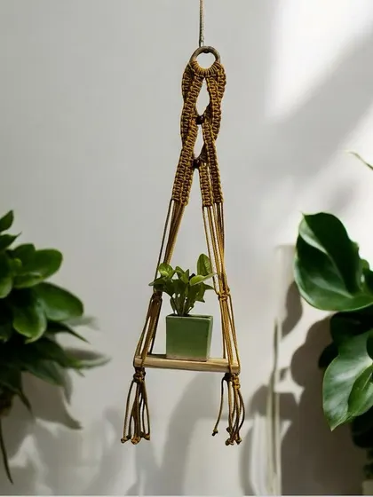 A single-tier wall planter shelf, styled beautifully in a minimalist setting. It's perfect for holding a small plant and adding a touch of nature indoors.