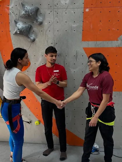 A handshake of respect between two competitors in the Women's Speed Climbing event. The community spirit is just as important as the competition itself.