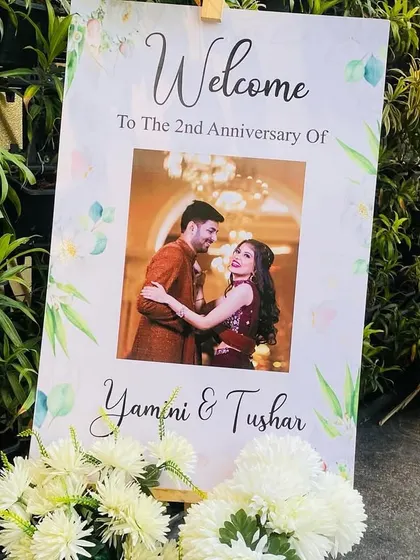 A personalized welcome sign for an anniversary party. This easel stand features a custom print with the couple's photo, welcoming guests to their 2nd-anniversary celebration.