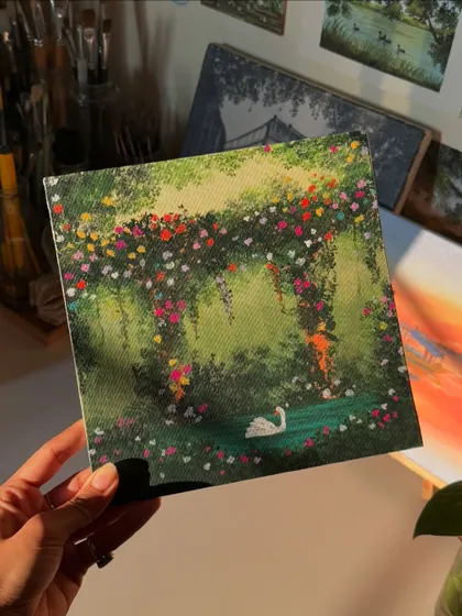 Holding the swan painting in my studio, surrounded by my art supplies. This piece brings so much color and joy to my space.