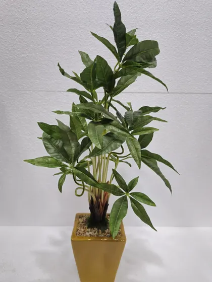 An artificial Pachira Aquatica (Money Tree) plant in a simple pot, known for its distinctive five-leaf stems.