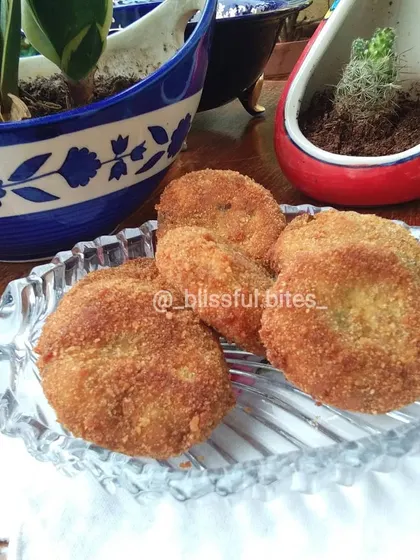 A serving of my homemade Malai Kebabs, perfectly fried to a golden brown. These creamy chicken cutlets are a savory delight for any occasion.