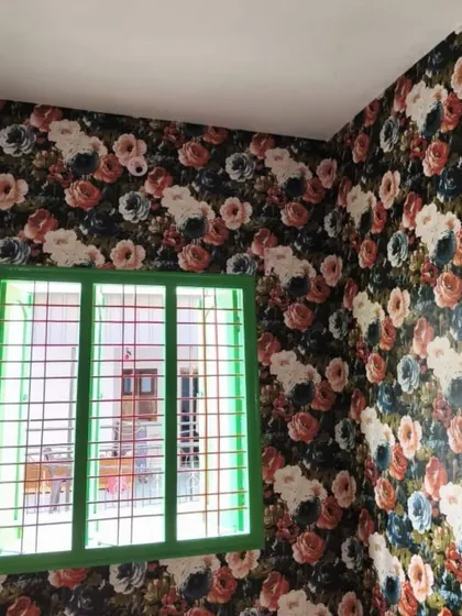 A bold and colorful floral wallpaper with a dark background makes a strong style statement. This design is perfect for a room where you want to add personality and drama.