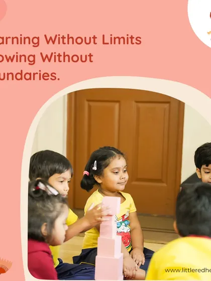 Learning without limits, growing without boundaries. A child carefully stacks pink blocks, demonstrating focus and an understanding of size and balance in this self-directed activity.