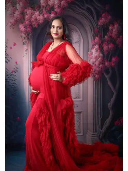 A stunning portrait in a red ruffled gown, set against a romantic, floral-themed painted backdrop. This creates a very classic and artistic feel.
