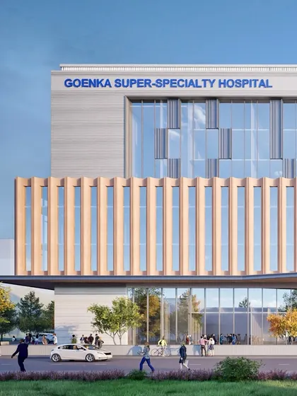 This rendering provides a glimpse of the Goenka Super Speciality Hospital in Bhopal, an upcoming 300-bed facility. The design features a modern facade with a mix of glass and solid panels, balanced with warm wood-like textures.