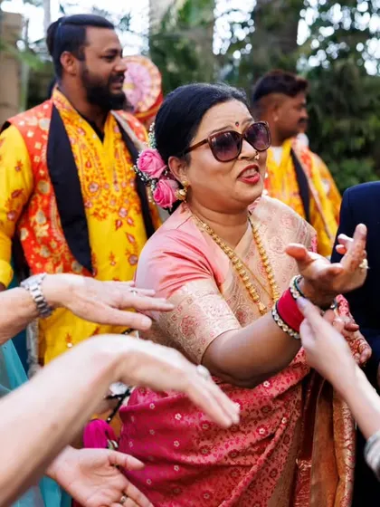 The mother of the groom, looking cool in her sunglasses, joins the dance party. I love capturing the joy of the whole family during the baraat.