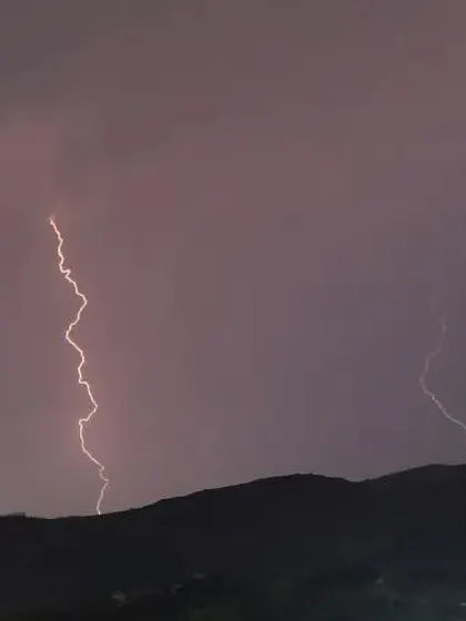This shot captures the storm as it moved over the hills. I used a long exposure to capture these distinct, powerful bolts of lightning as they lit up the night.