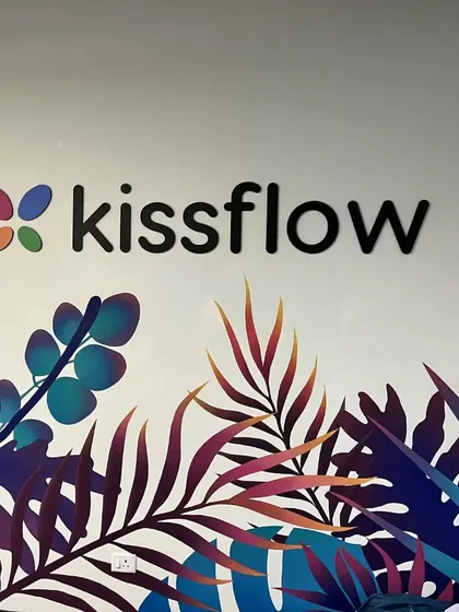 The Kissflow logo is integrated into a vibrant, tropical-themed wall mural. This artistic approach to branding infuses the workspace with color and personality, moving beyond a simple corporate sign.