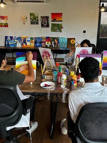 A view of our workshop space, with everyone busy at their easels. The walls are decorated with paintings from past events, providing plenty of inspiration.