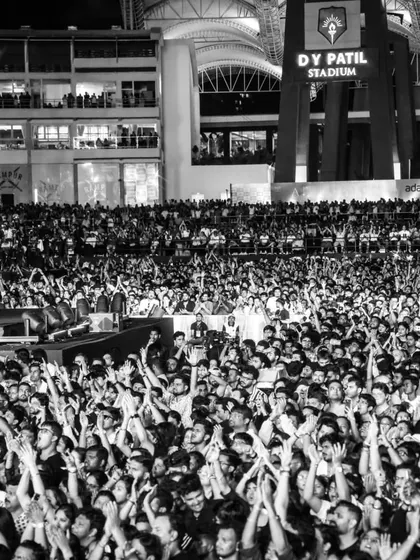 The energy of a packed stadium is electric. This black and white shot from the D.Y. Patil Stadium shows a massive, engaged audience, a result of our meticulous planning in ticketing, promotion, and crowd flow management.