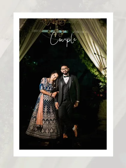 An elegant full-length portrait of the couple at their reception, framed by beautiful drapery and lighting.