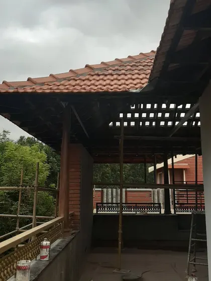 An exterior view of the restoration, showing the beautiful sloping roof with Mangalore tiles being preserved. The structure is supported as we work to strengthen and adapt the space for contemporary use.
