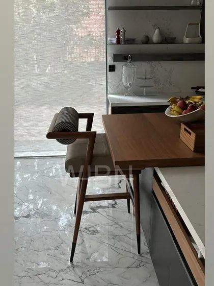 A side profile of our custom barstool, highlighting the expert joinery and the elegant tapering of the solid wood legs.