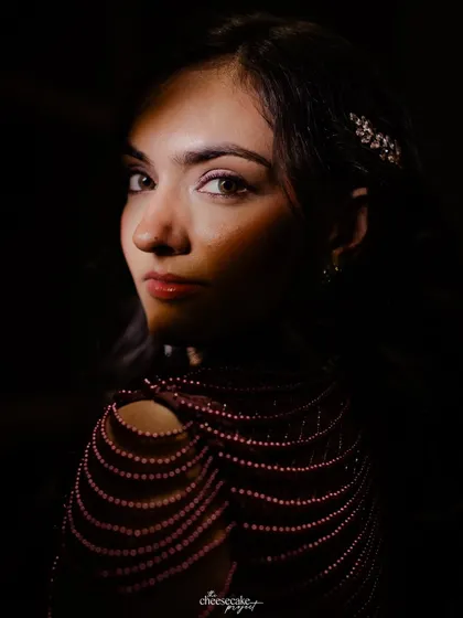 A stunning, dramatic close-up portrait of the bride, using shadows to highlight her features.