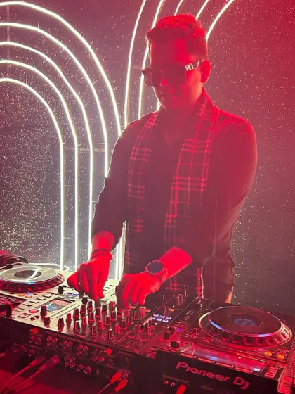 A stylish shot of me at the console, surrounded by neon lights. The visual aesthetic of an event is just as important as the music.