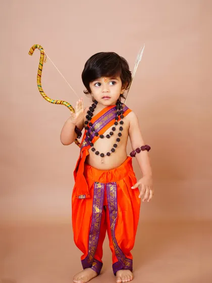 A little boy dressed as Lord Rama for a Ram Navami themed shoot, holding a bow and arrow. I love bringing these creative cultural ideas to life.