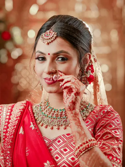 A charming close-up of the bride playfully touching her nose ring, her smile lighting up the photo.
