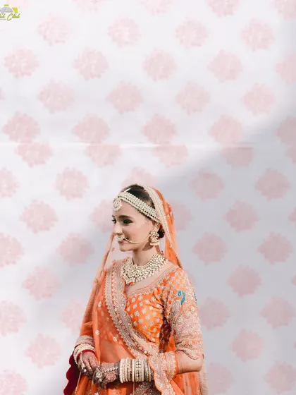 A beautiful portrait of the bride against a patterned backdrop. The play of light and shadow adds depth and artistry to this elegant shot.