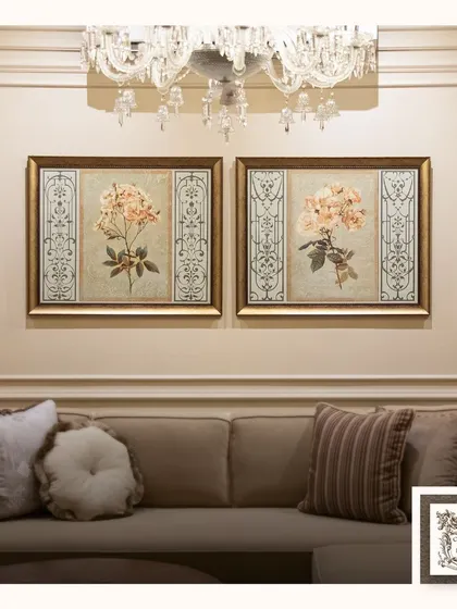 This pair of 'Heritage Roses' prints brings a touch of classic botanical beauty to the space. Hung above a neutral sofa and under a crystal chandelier, they add to the room's timeless elegance.