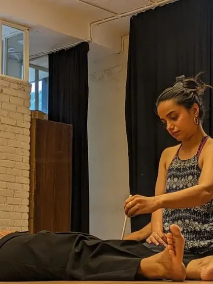 Embrace the freedom of intuitive body movement. Here, a participant uses a tuning fork, incorporating sound healing into our therapeutic practice.