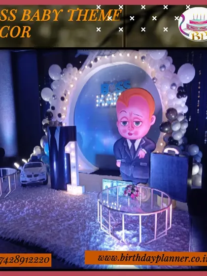 Another take on the popular Boss Baby theme, this time with a circular backdrop and lounge setup. The scene is set with a large character prop, a miniature car, and modern glass tables on a plush rug.